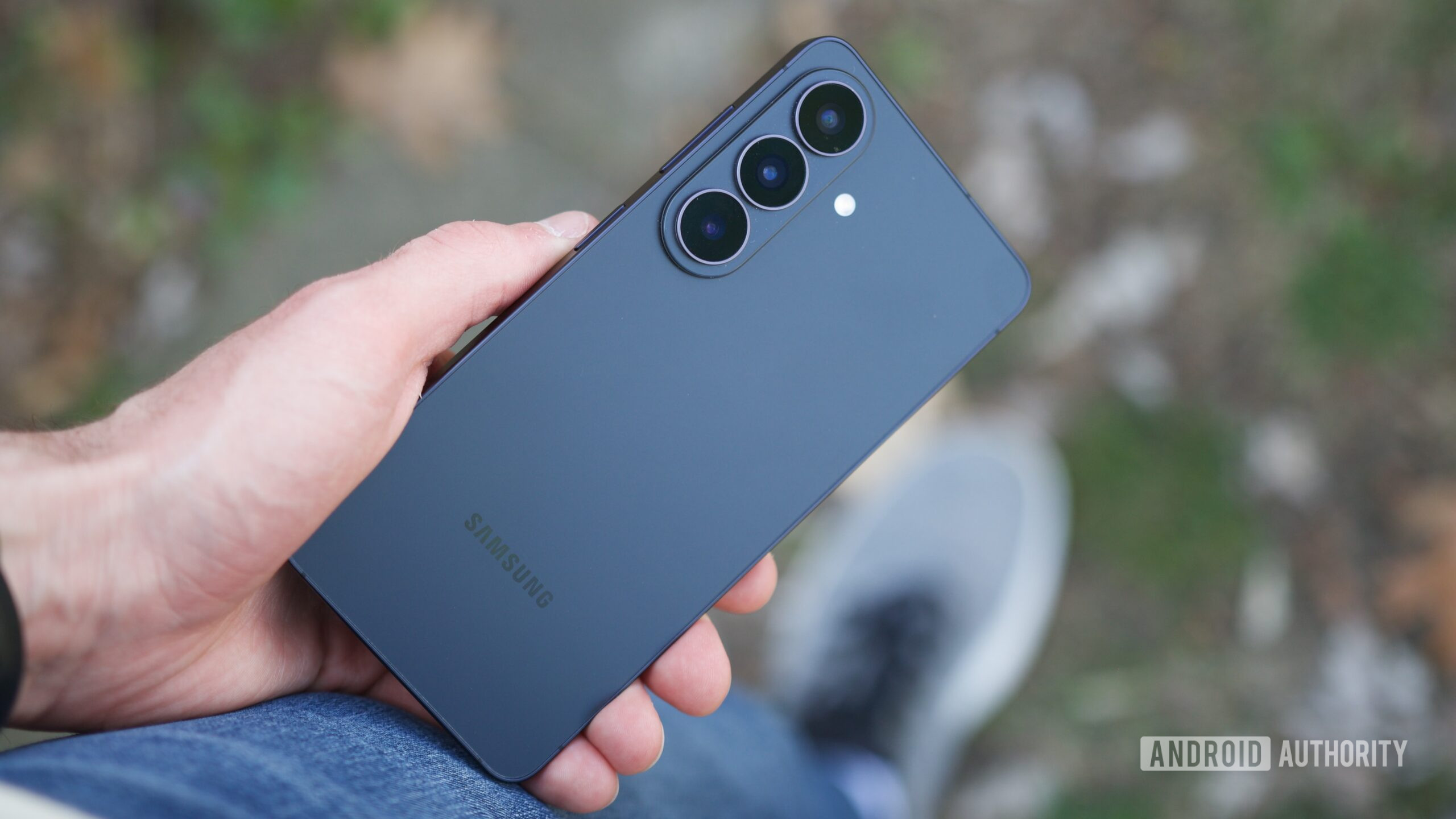 Holding the back of the Galaxy S26