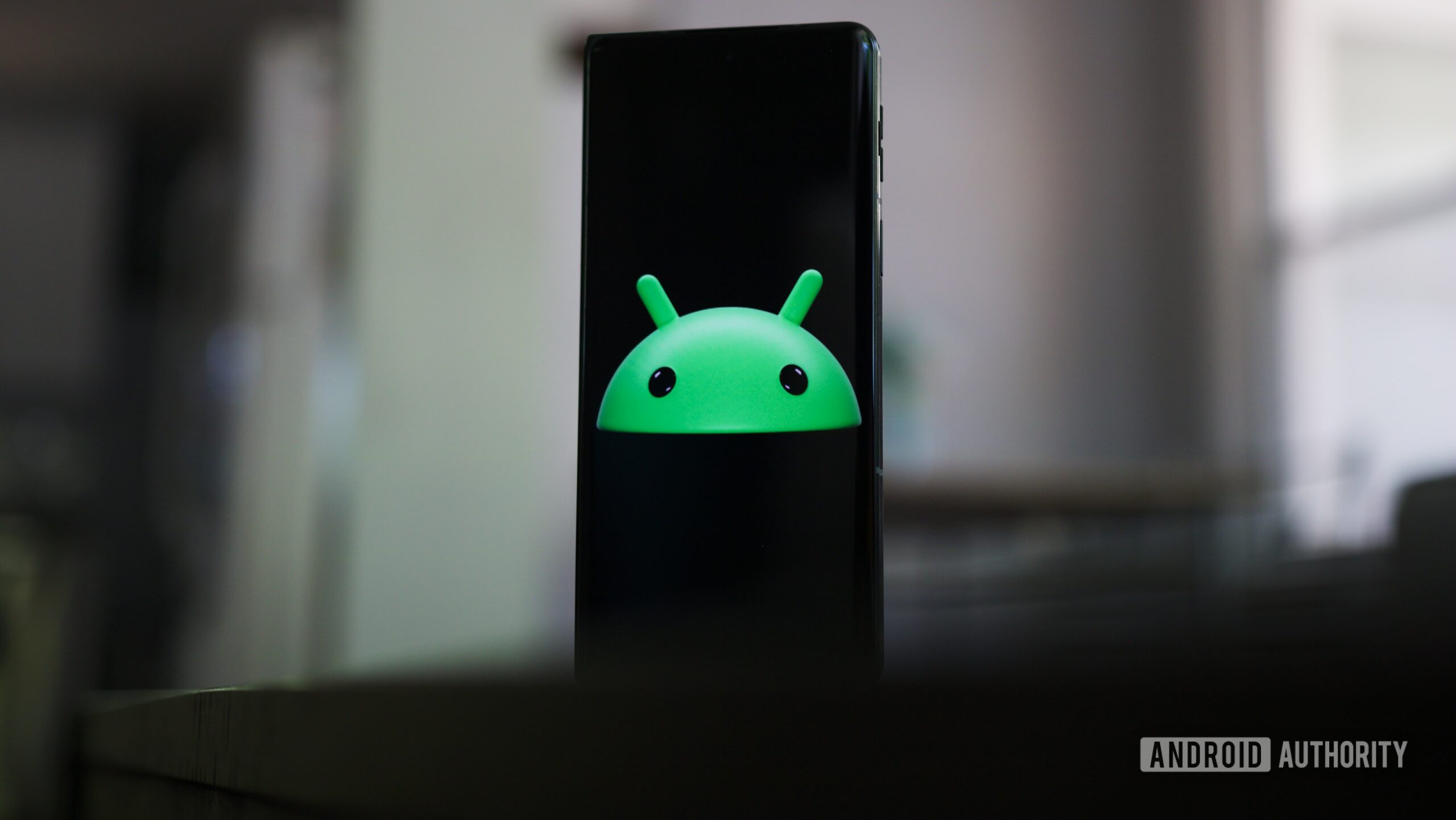 Green Android logo head on a smartphone.