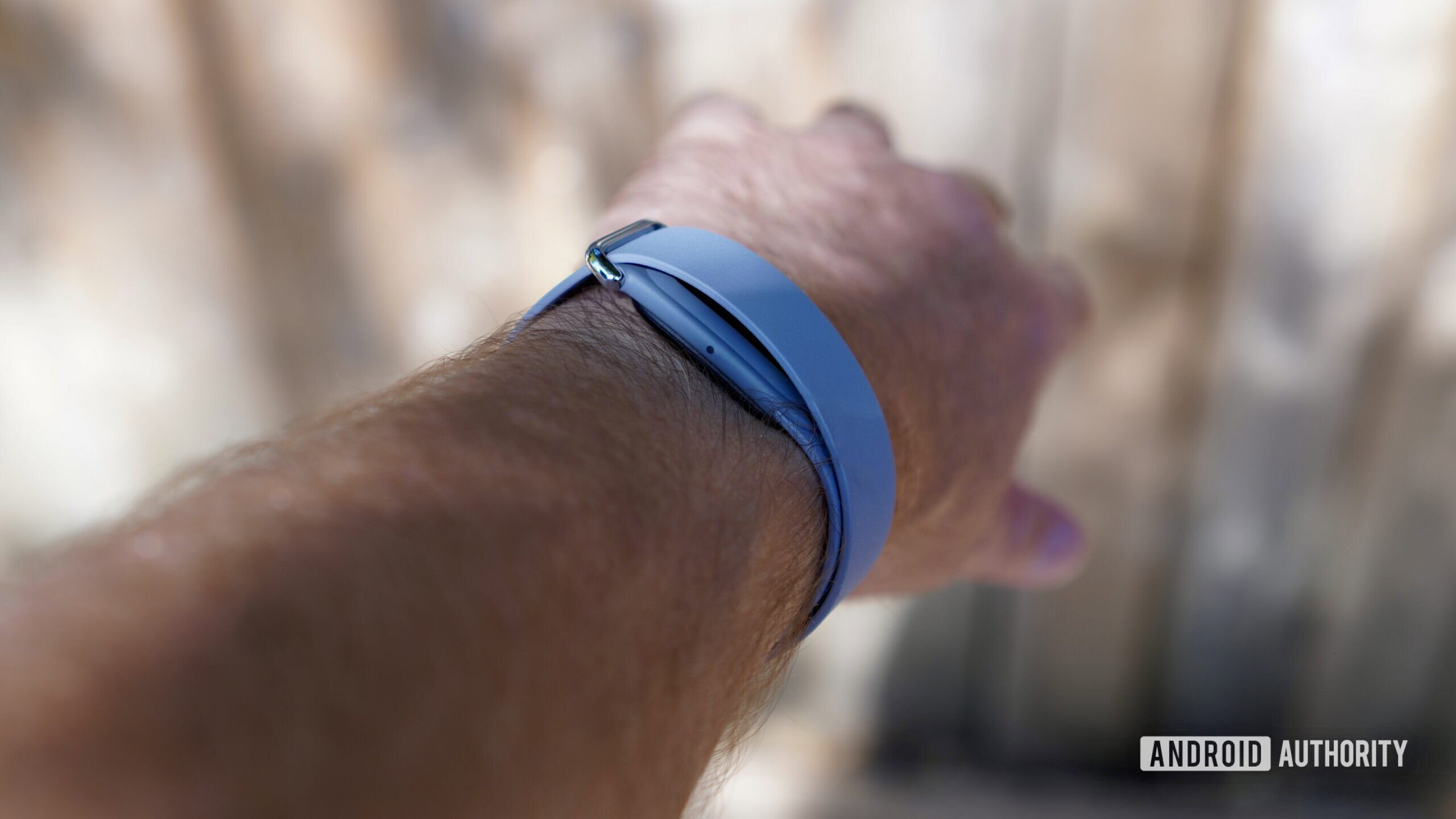 Side view of a person wearing the Fitbit Air.